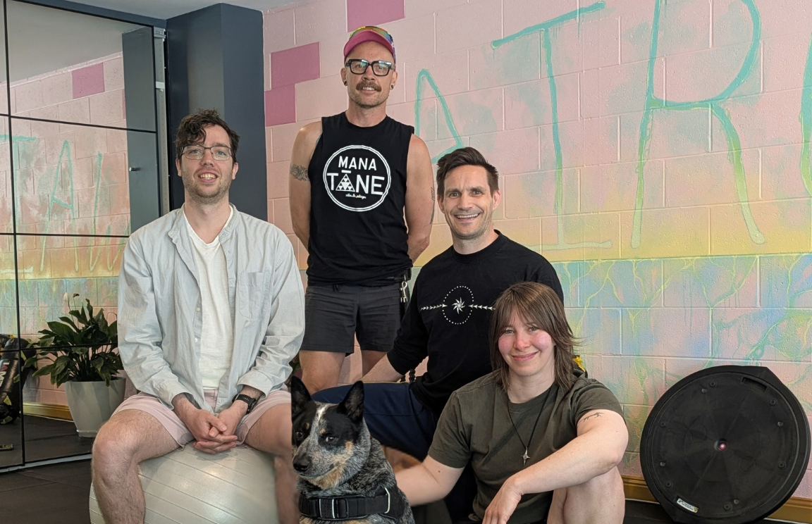 Don, Matt, Nick and Charlie with Cosmo the studio dog in front of the painted studio wall
