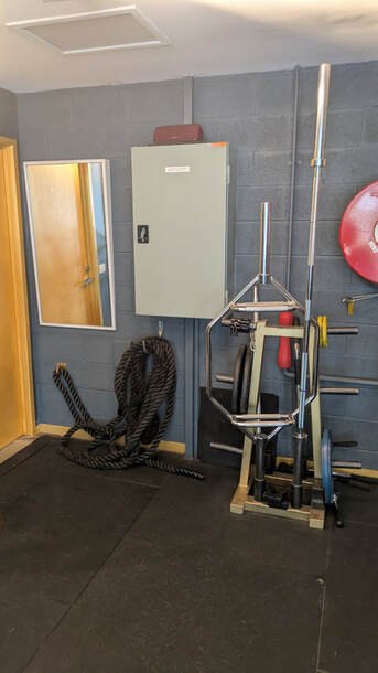 Squat rack and battle ropes in the studio